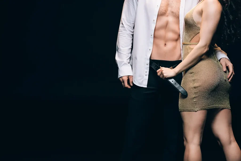 Woman in a stripper dress undressing her man