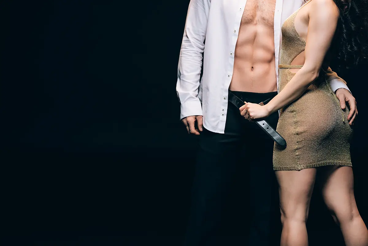 Woman in a stripper dress undressing her man