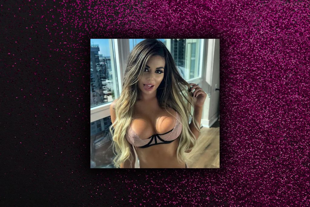 Brazil in a pink bra getting ready for a private lap dance