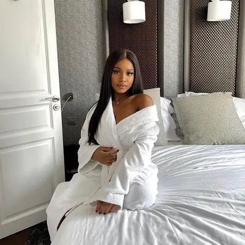 Cindy sitting on her bed